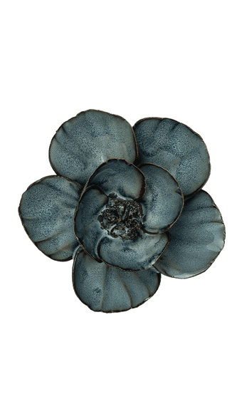 A single flower-shaped decorative object with five rounded petals in a mottled slate blue-gray color, isolated on a solid black background.