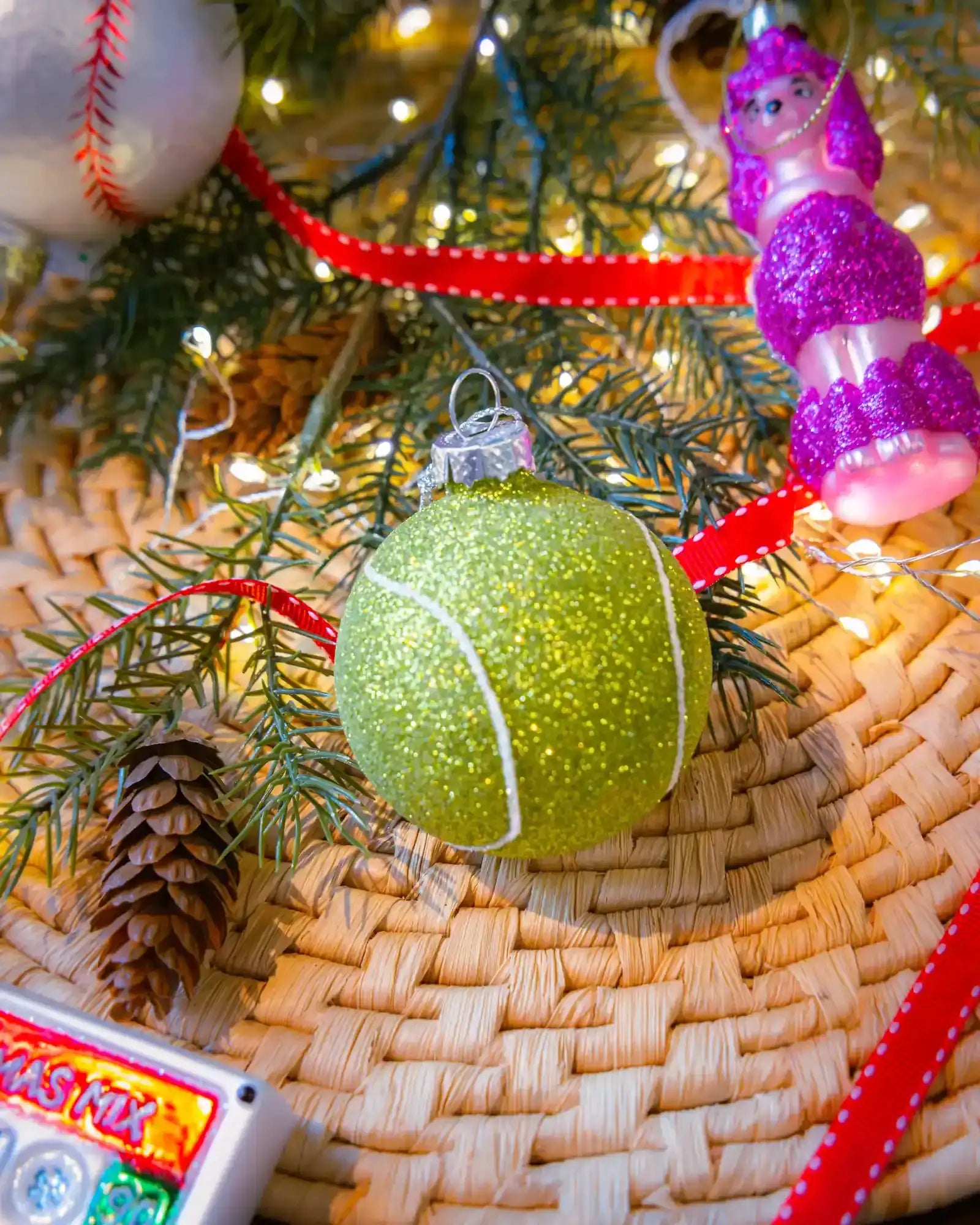 Tennis ball ornament styled on a decorated Christmas tree