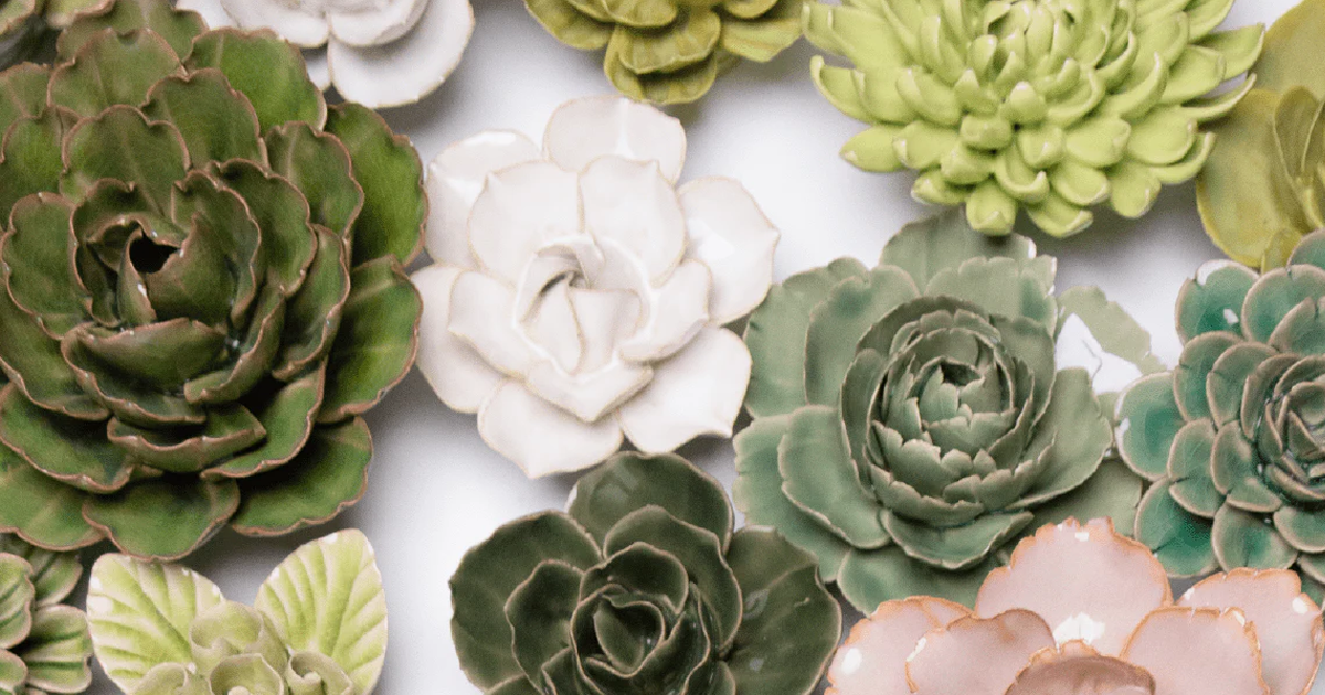 Ivory daffodil ceramic wall flower surrounded by jade green and fir green English Garden ceramic flowers on white background — handmade by Chive Studio Toronto