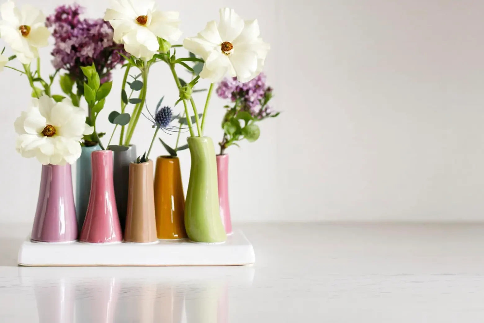 Pooley Magenta 8 Tube Ceramic Flower Vase - Close up of styled decorative vases with an arrangement of flowers for a table or desk setting