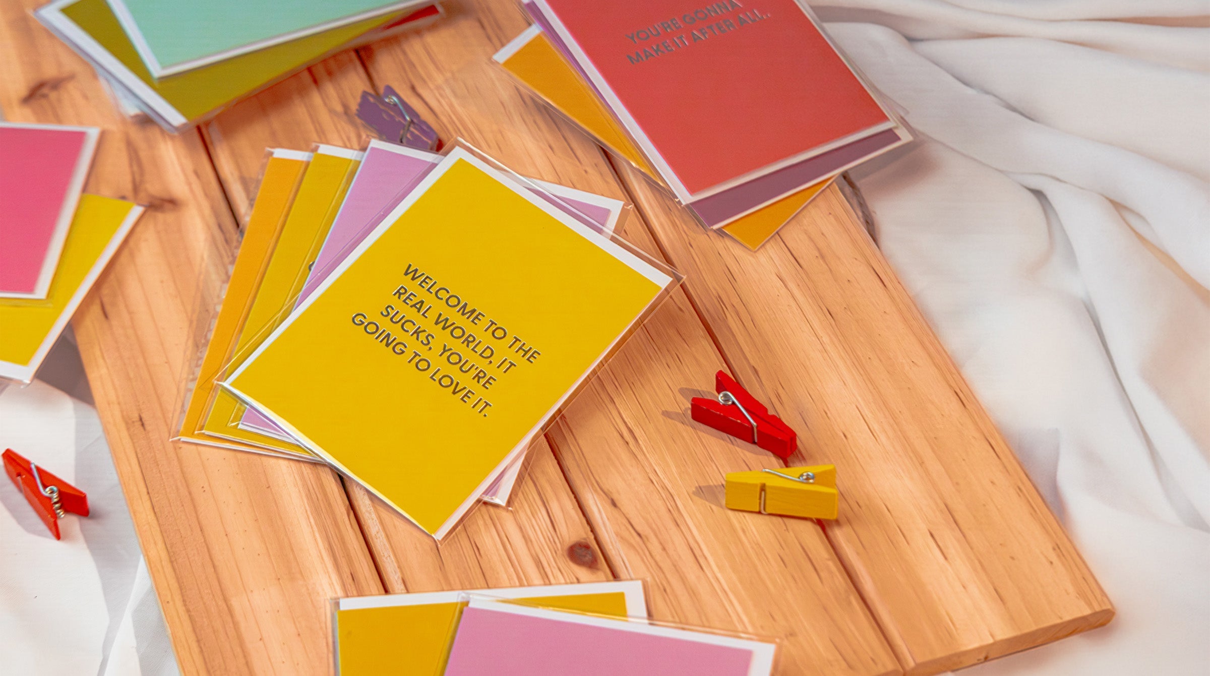 Graduation cards and milestone congratulations cards fanned out — by Chive Studio