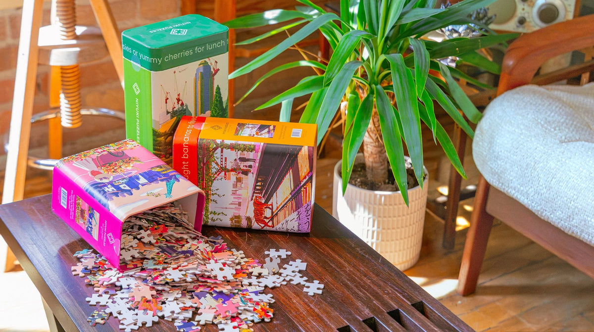 Unique puzzles for adults from the Niyuki 500-piece collection, boxes stacked — by Chive Studio