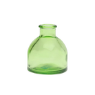 Chive Loft round glass bud vase in green with a domed silhouette and short neck.