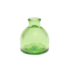Chive Loft round glass bud vase in green, shown straight-on with a smooth glossy finish.