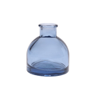 Chive Loft round glass bud vase in medium blue with a domed silhouette and short neck.