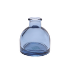 Chive Loft round glass bud vase in medium blue, shown straight-on with a smooth glossy finish.