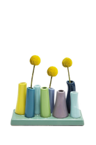Chive Pooley ceramic bud vase set in Buttercup pairs teal, mauve, and navy tubes on a sage green tray.