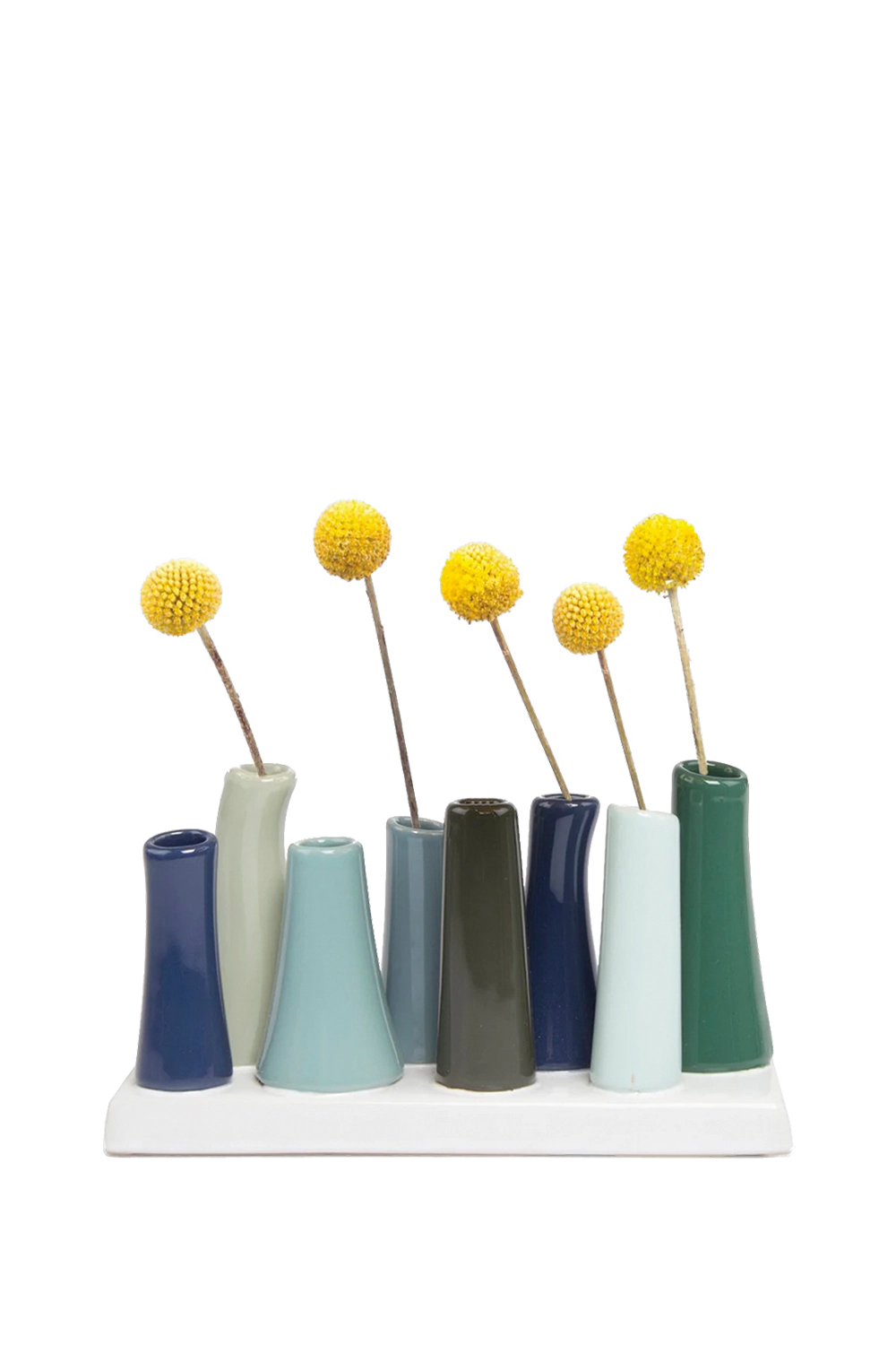 Chive Pooley ceramic bud vase set in Forest showcases cool-toned tubes in a tightly clustered mixed arrangement.