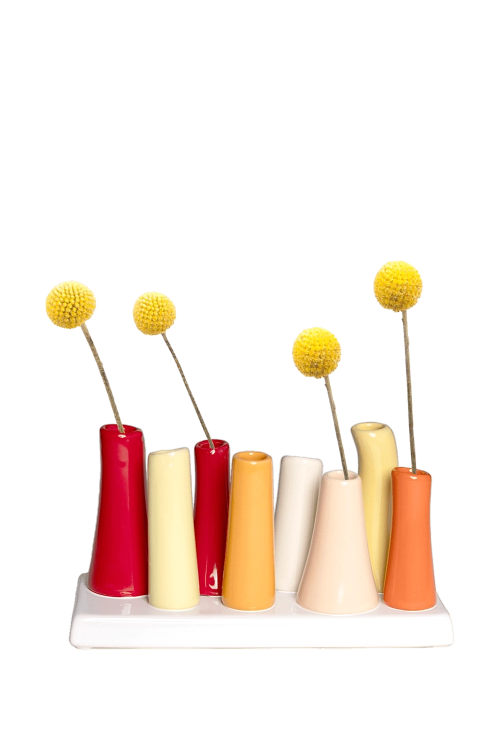 Chive Pooley ceramic bud vase set in Strawberry Shortcake holds tall tapered tubes in warm mixed hues on a connected tray.