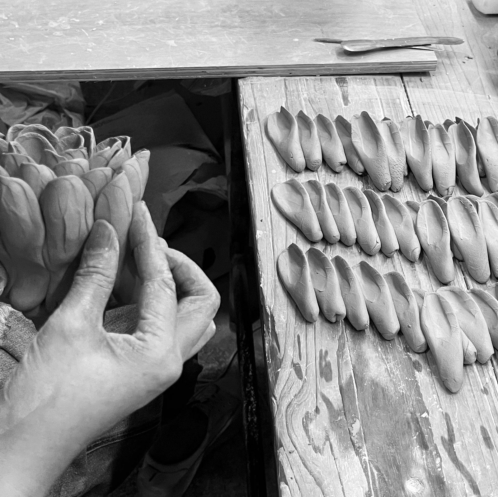 Chive artisan hand-shaping ceramic flower petal without molds in
Toronto studio, 25 years of handmade ceramic flowers