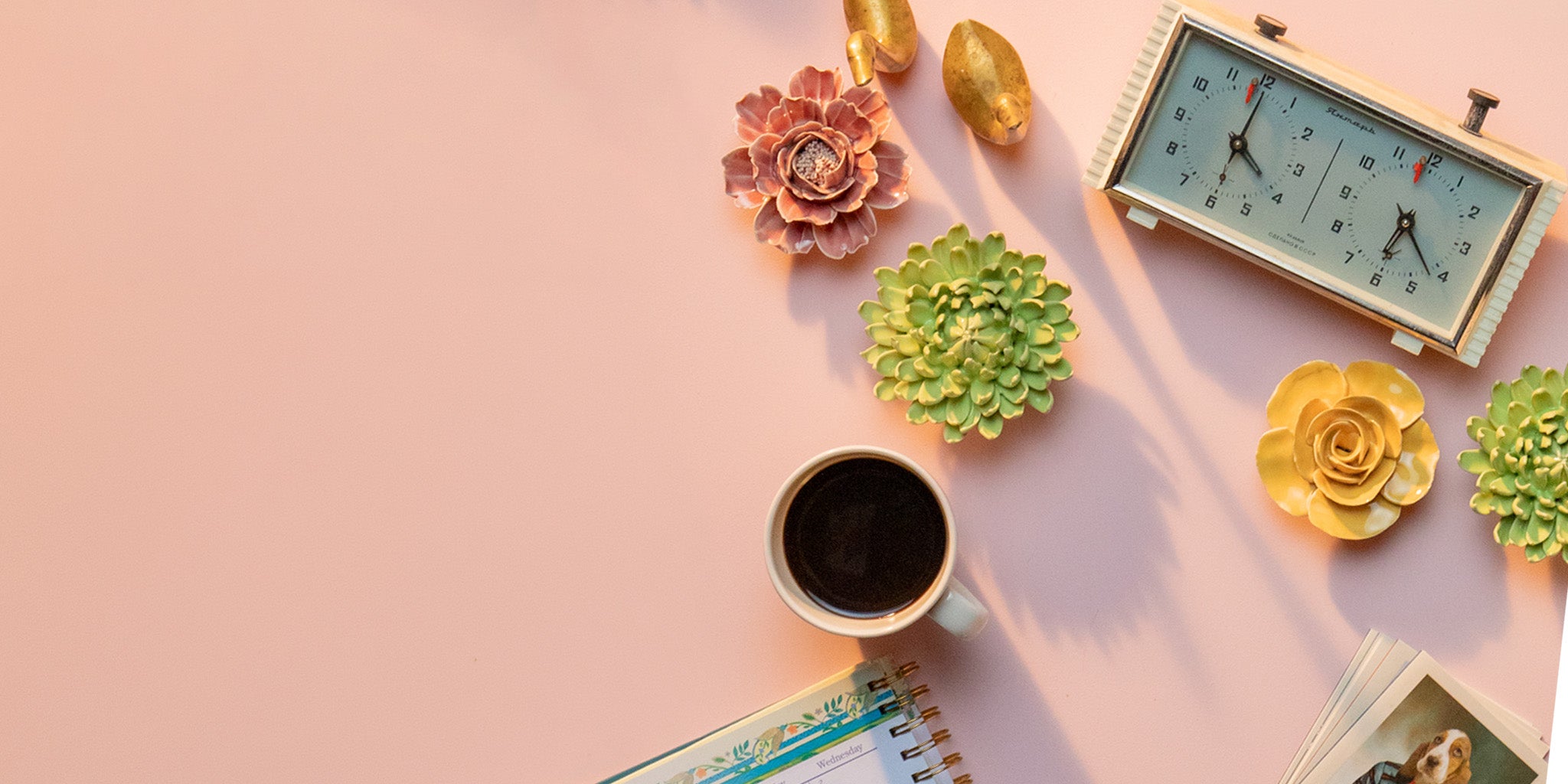 Chive Studio ceramic wall flowers styled on pink tabletop with coffee calendar clock and pictures — Chive Studio