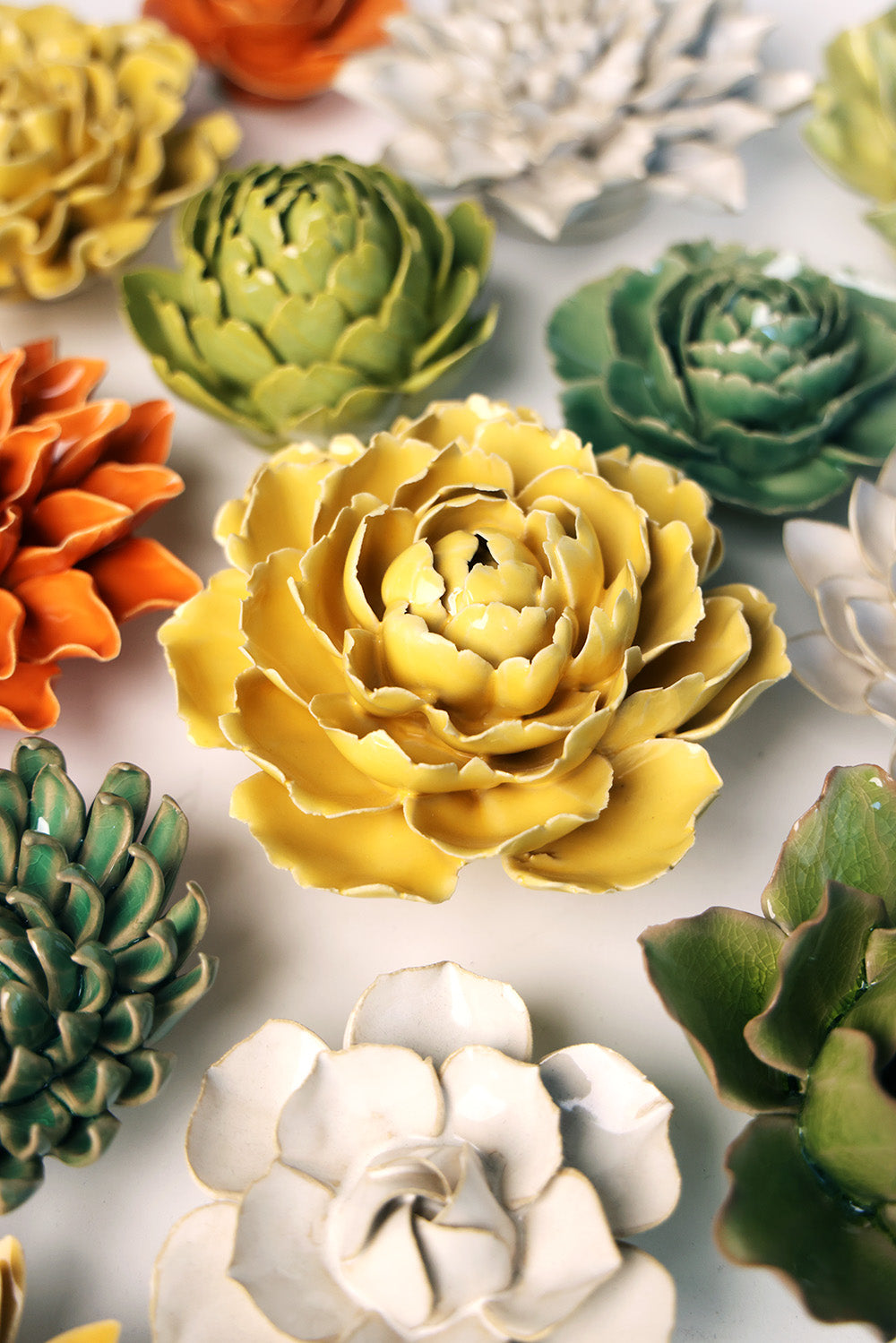 Buttercup Yellow Gay Paree Peony ceramic wall flower mounted on a wall — Chive Ceramics Studio