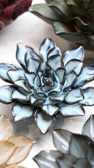 Blue Alpine Aster ceramic wall flower styled on a white table with other flowers — Chive Studio