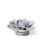 A small sculptural flower-shaped object in a matte light gray finish with subtle speckling, photographed on a clean white background.