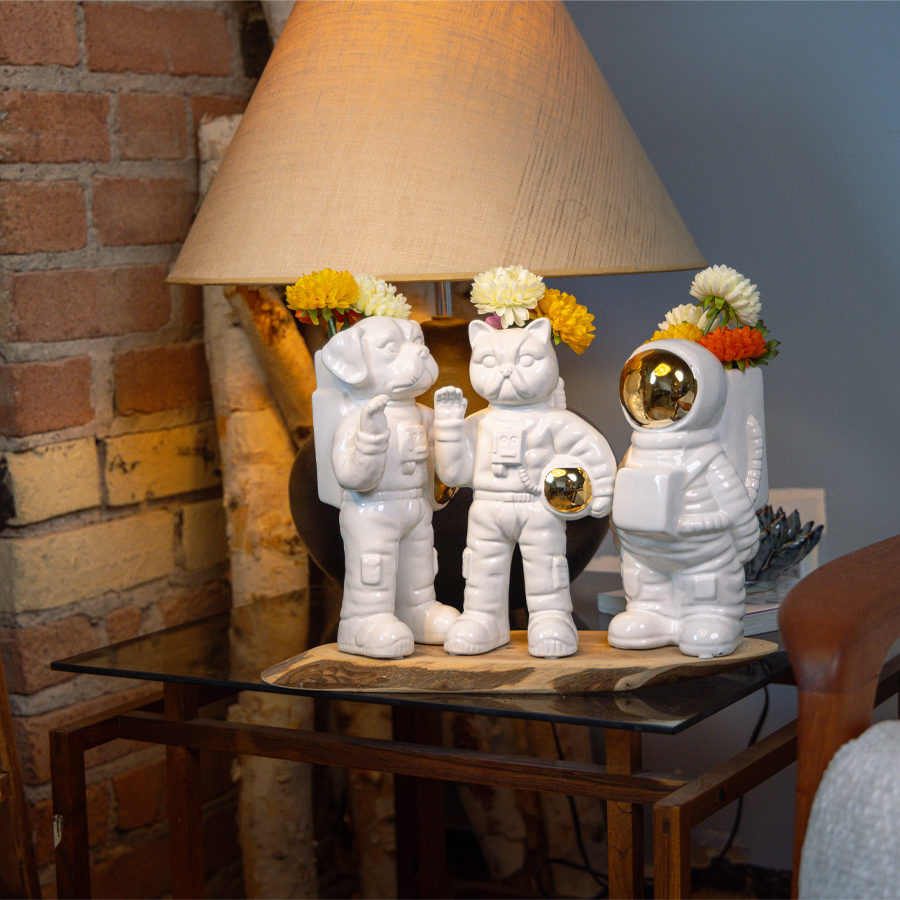 Ceramic astronaut vase with flowers styled on shelf — Chive Studio Toronto