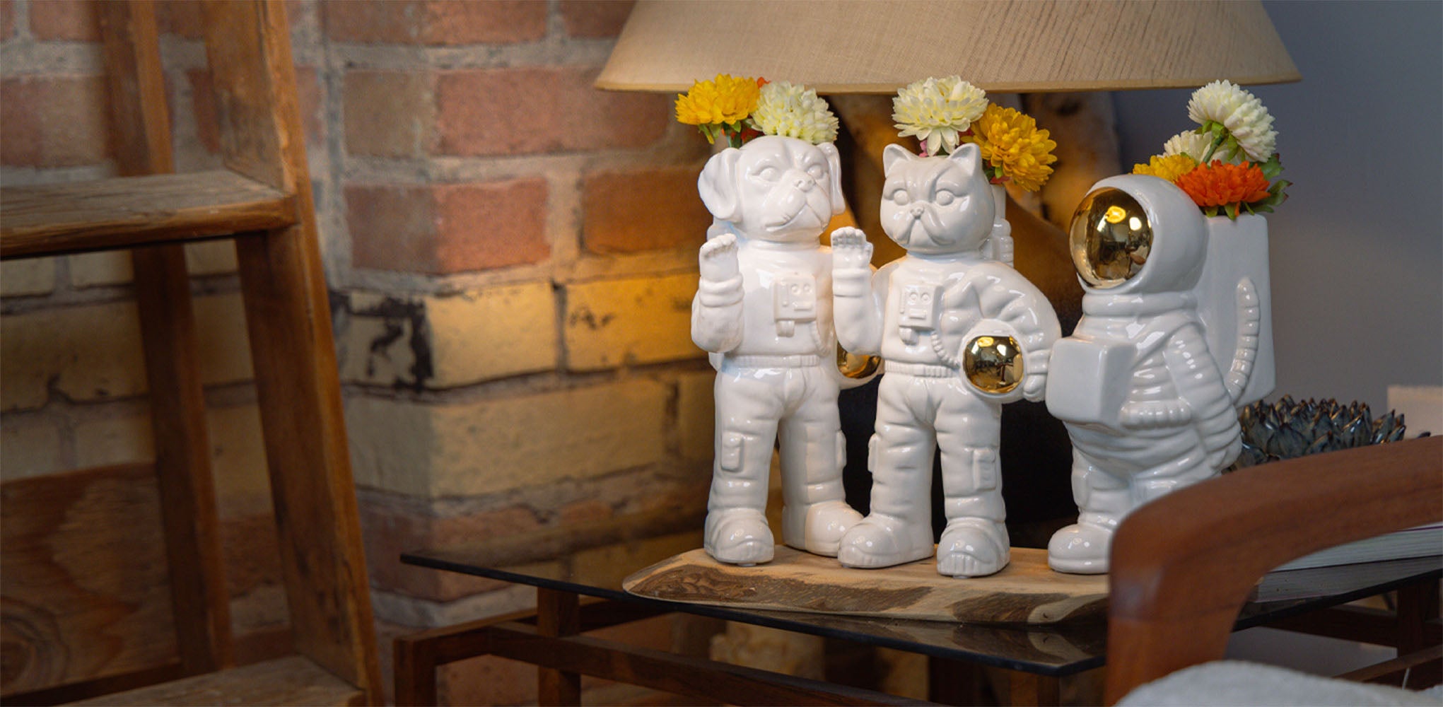 Ceramic astronaut vase with flowers styled on shelf — Chive Studio Toronto