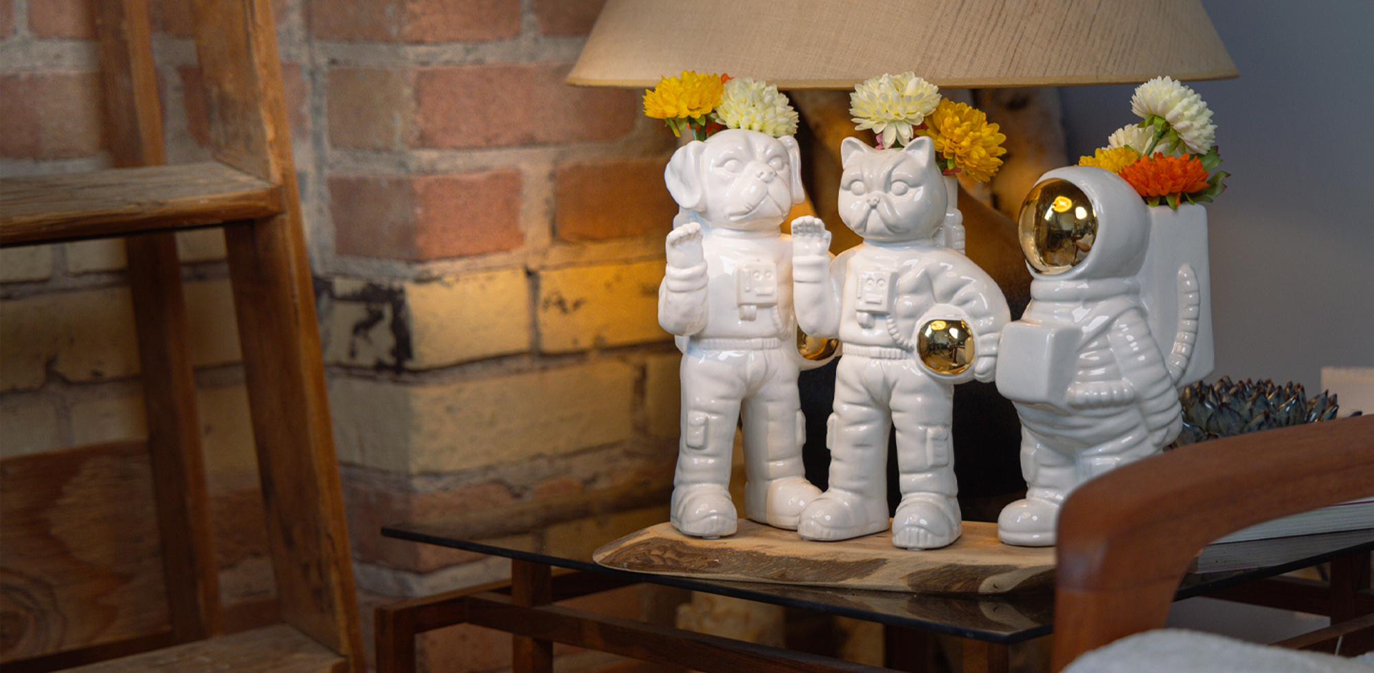Ceramic astronaut vase with flowers styled on shelf — Chive Studio Toronto