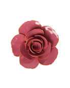 A glossy rose-shaped decorative object or accessory in a deep pinkish-red color with a subtle gold-toned edge, isolated on a solid black background.