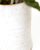 Close-up of the pattern and glaze finish on a Chive Channa white speckles ceramic small pot.
