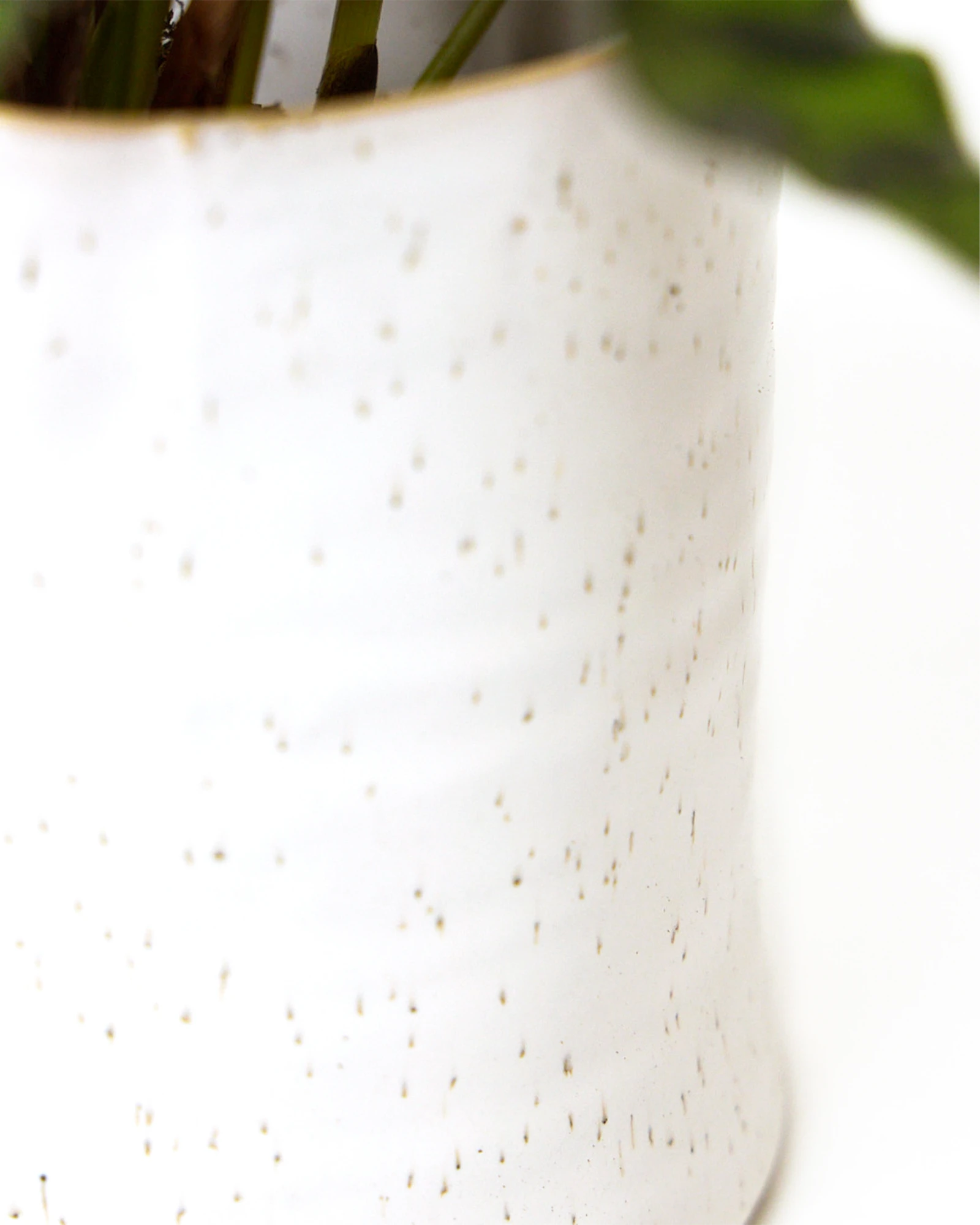 Close-up of the pattern and glaze finish on a Chive Channa white speckles ceramic small pot.