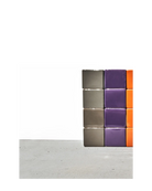Chive Cube Saucer ceramic planters stacked in columns of grey, purple, and orange on a concrete floor.