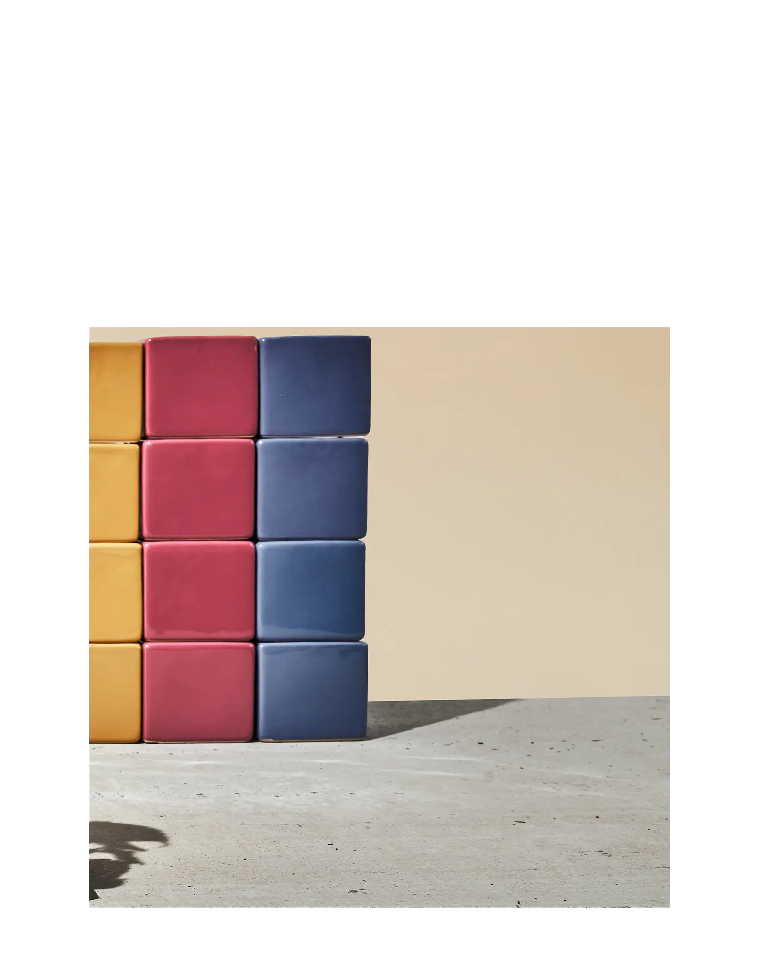 Chive Cube glazed ceramic mini square planters stacked in goldenrod, pink, and blue.