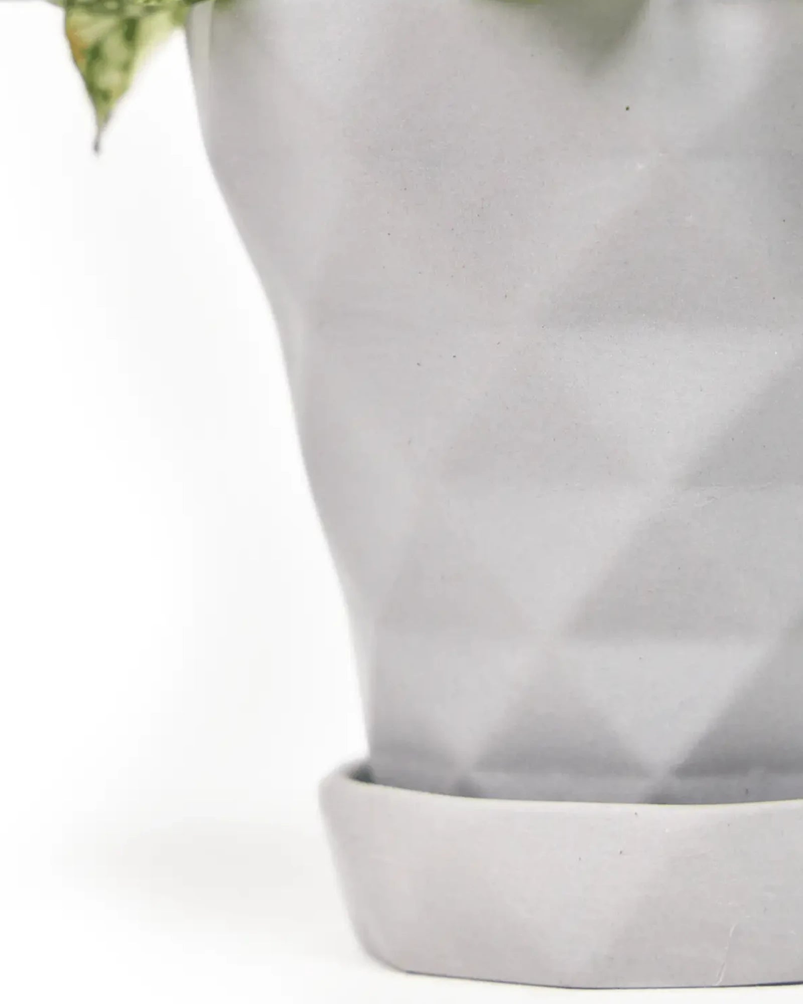 Close up of Chive Diamond medium light grey porcelain pot with drainage and detachable saucer, showing the texture finish.
