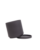 A matte black cylindrical container with its matching round lid resting beside it on a clean white background.