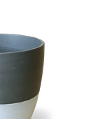Close-up of the Chive Dyad small black porcelain pot showing the surface texture and finish.