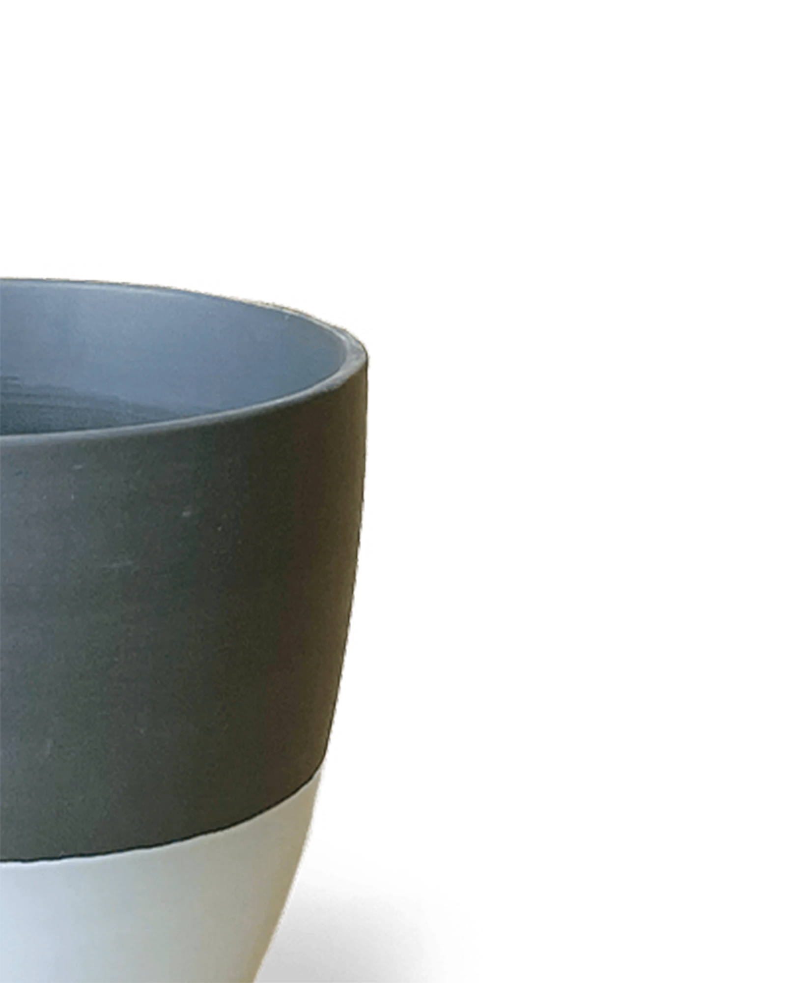 Close-up of the Chive Dyad small black porcelain pot showing the surface texture and finish.