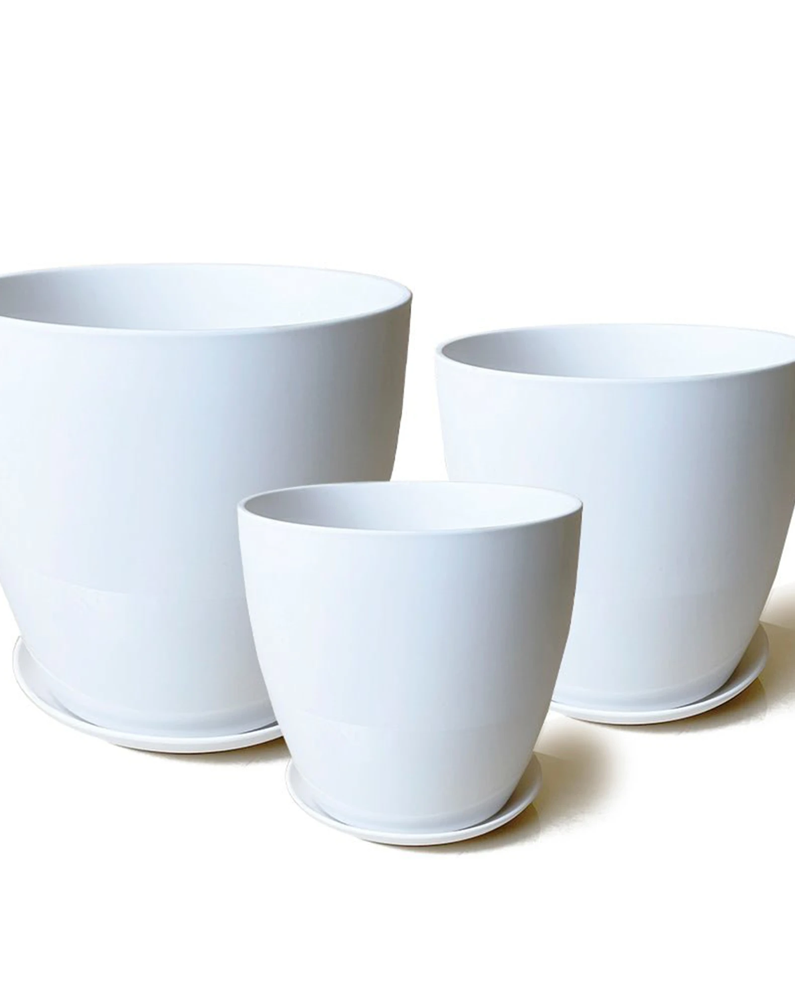 Three Chive Dyad white porcelain pots with drainage and detachable saucers in large, medium, and small.