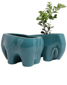 Two Chive Elephant Teal color glazed ceramic elephant shaped planters styled with a plant.