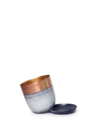 Chive Joe white copper medium metal planter with drainage tipped to show the warm copper interior finish and the detachable saucer.