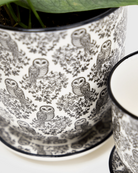 Close-up of two Chive Liberte black owls porcelain pots showing the pattern and glaze finish.