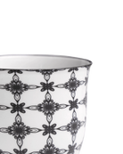Close-up of the Chive Liberte medium black stars porcelain pot showing the pattern and glaze finish.