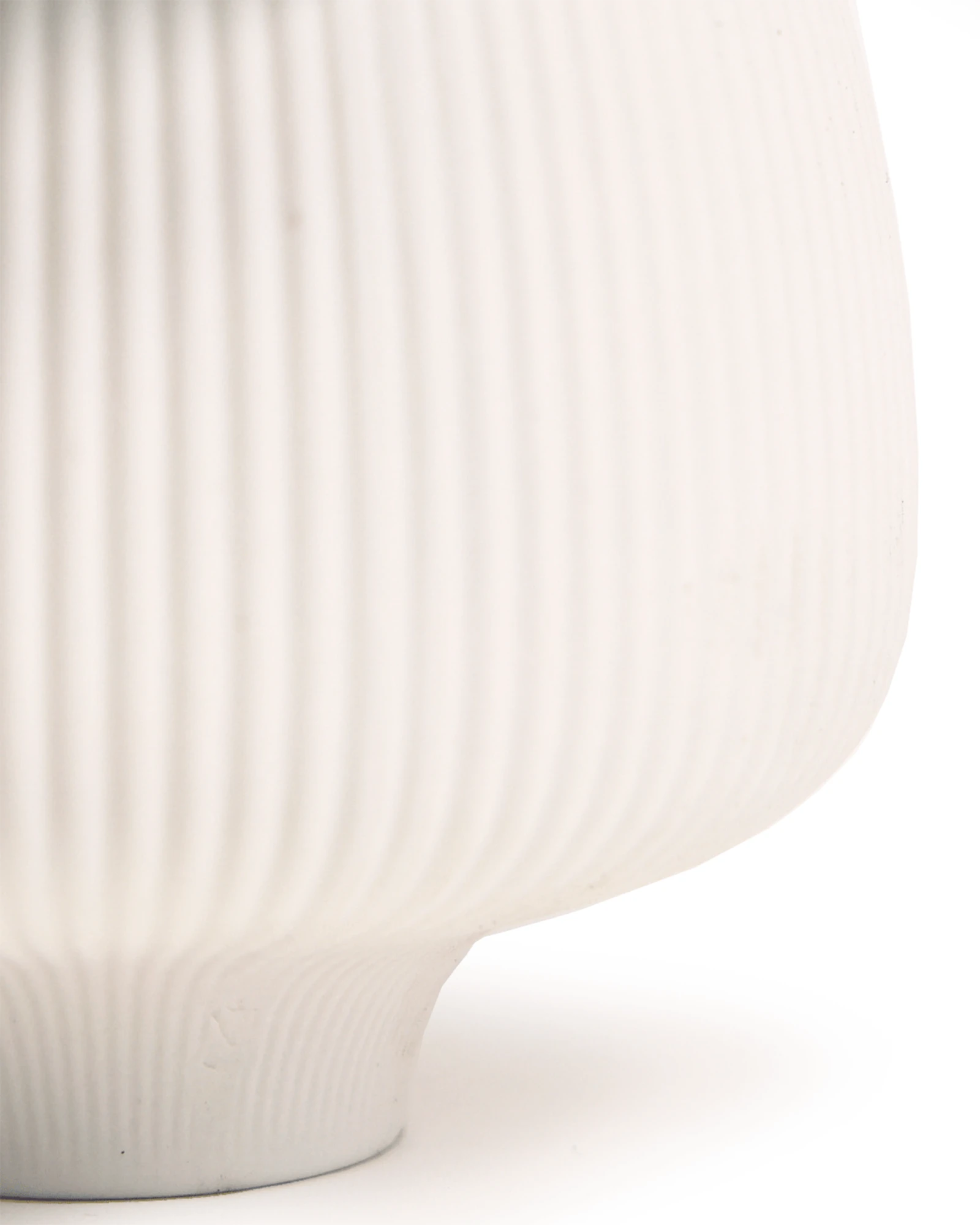 Close-up of the matte and ribbed finish on a Chive Lilo white porcelain large plant pot.