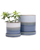 Two Chive Minute fully glazed ceramic planter pots in color blue layers styled with a plant.