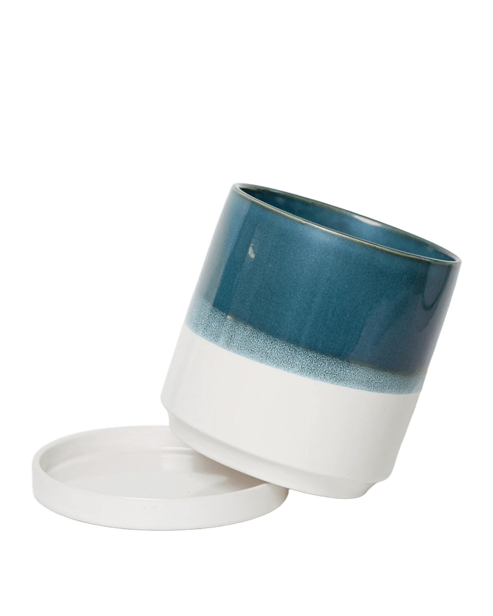 Chive Minute small green-blue ceramic pot with drainage tilted to show the detachable saucer.
