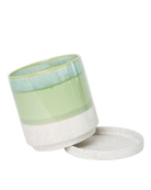 Close-up of the detachable saucer on a Chive Minute large green cement ceramic pot with drainage.