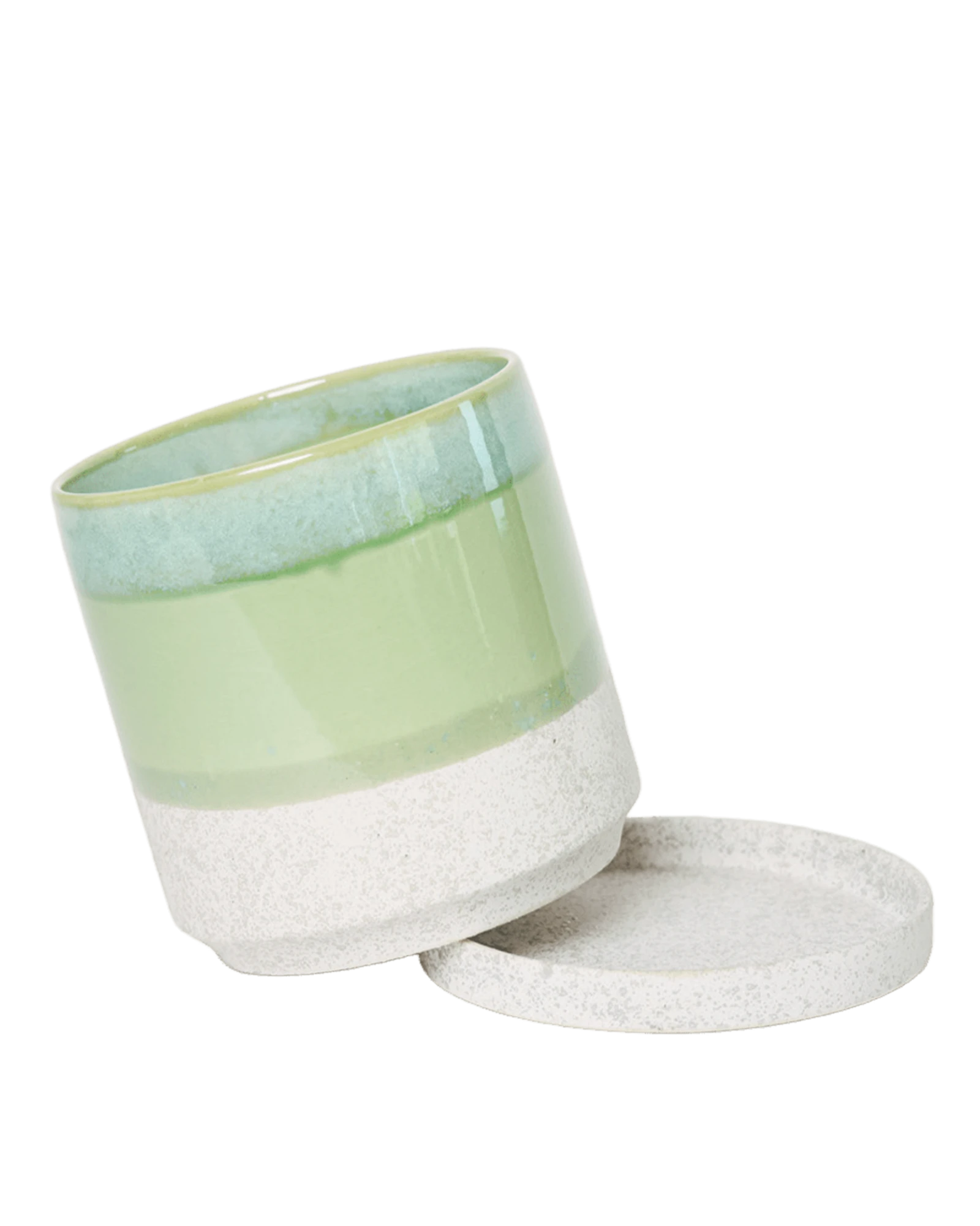Chive Minute small green cement ceramic pot with drainage tilted to show the detachable saucer.