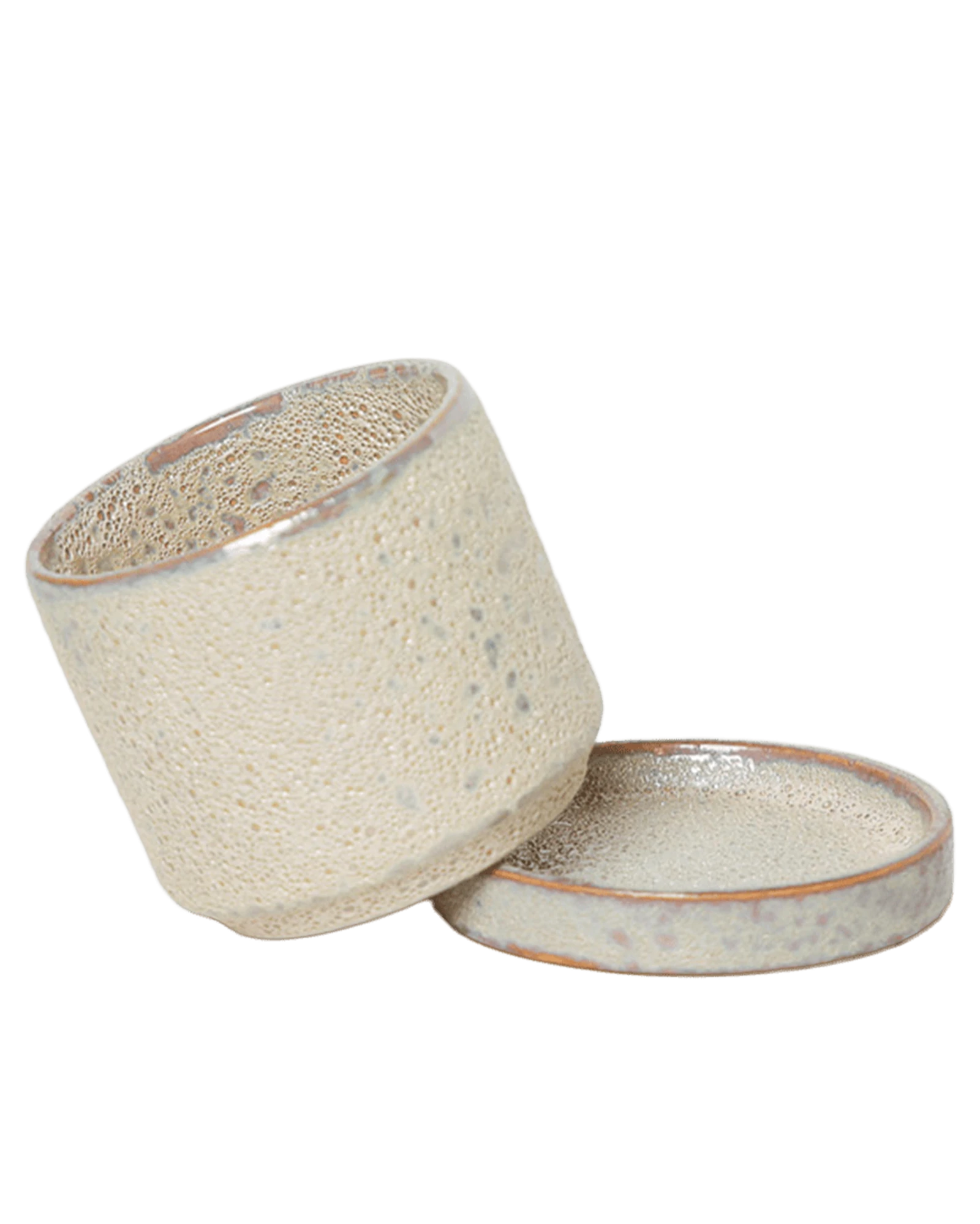 Chive Minute small ivory speckles ceramic pot with drainage tilted to show the detachable saucer.