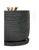 Close-up of the detachable saucer and ribbed texture on a Chive Paul black ceramic pot.