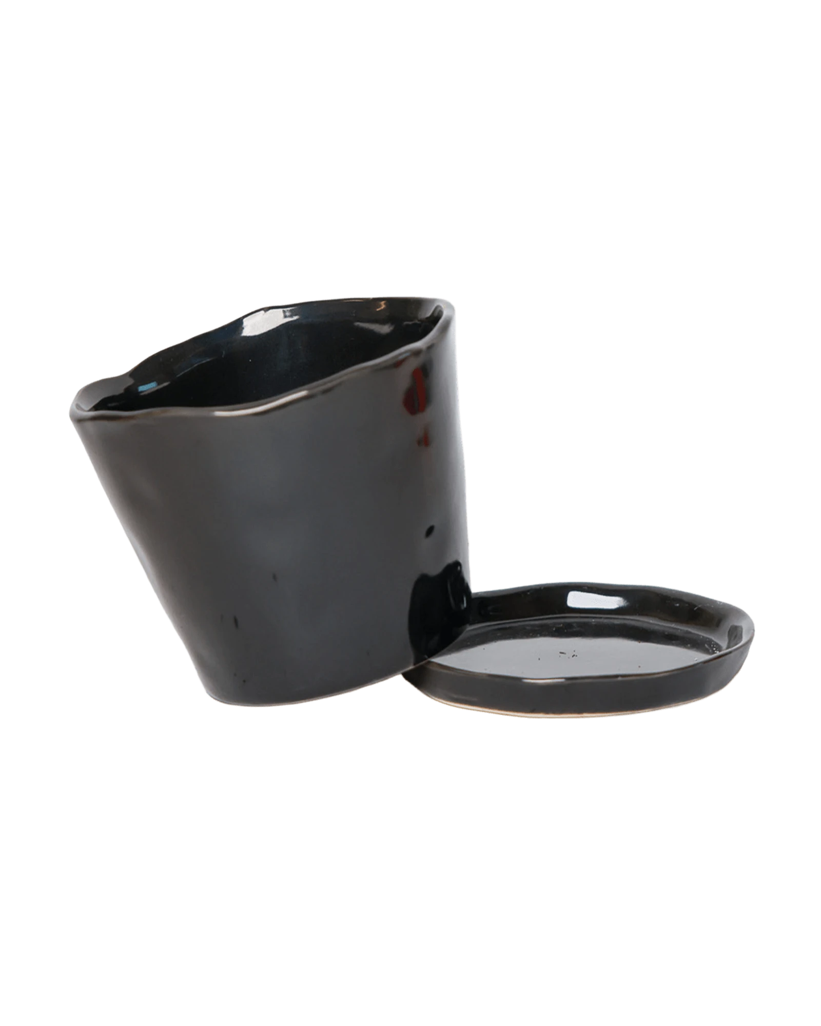 Chive Tika black ceramic large plant pot with drainage tilted to show the detachable saucer.