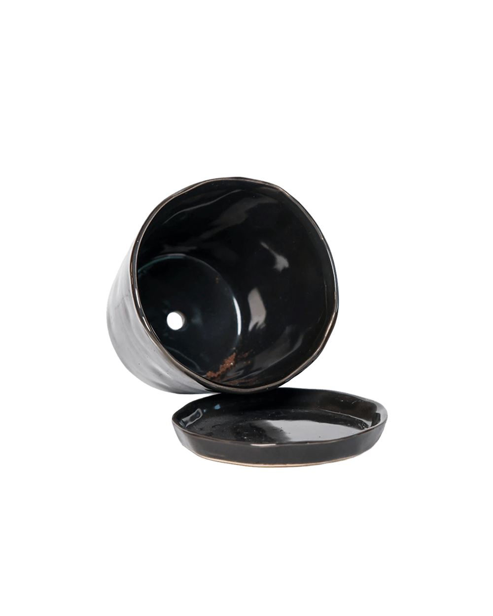 Close-up of the detachable saucer and drainage hole on a Chive Tika black ceramic large pot.