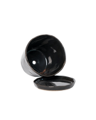 Close-up of the detachable saucer and drainage hole on a Chive Tika black ceramic large pot.