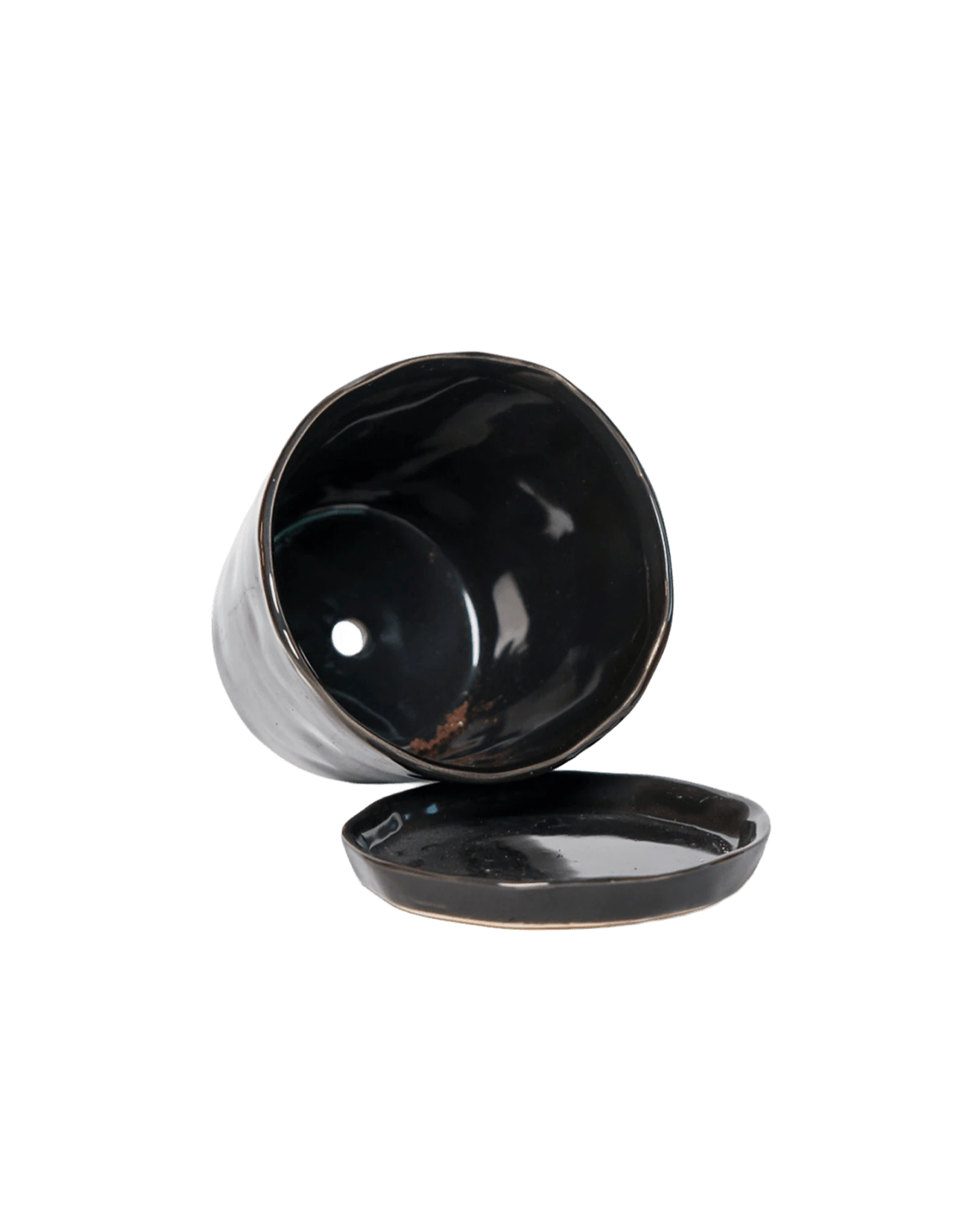 Close-up of the detachable saucer and drainage hole on a Chive Tika black ceramic large pot.