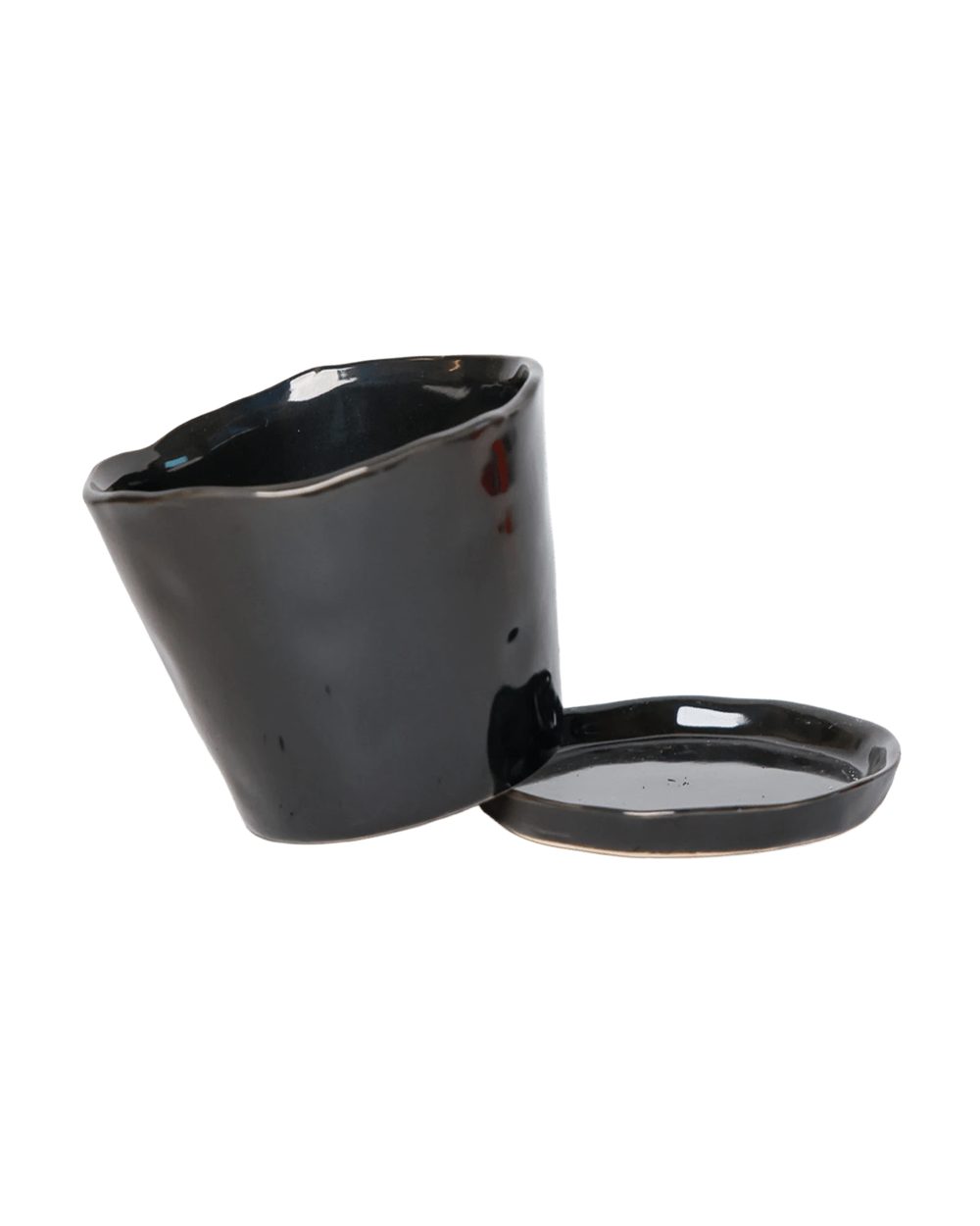 Close-up of the detachable saucer and drainage hole on a Chive Tika black ceramic medium pot.