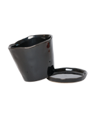 Close-up of the detachable saucer and drainage hole on a Chive Tika black ceramic medium pot.