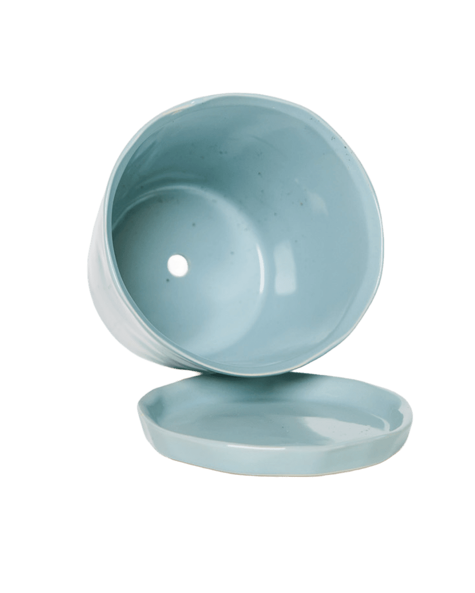 Close up of Chive Tika large new grey ceramic planter pot, showing the drainage hole and detachable saucer.