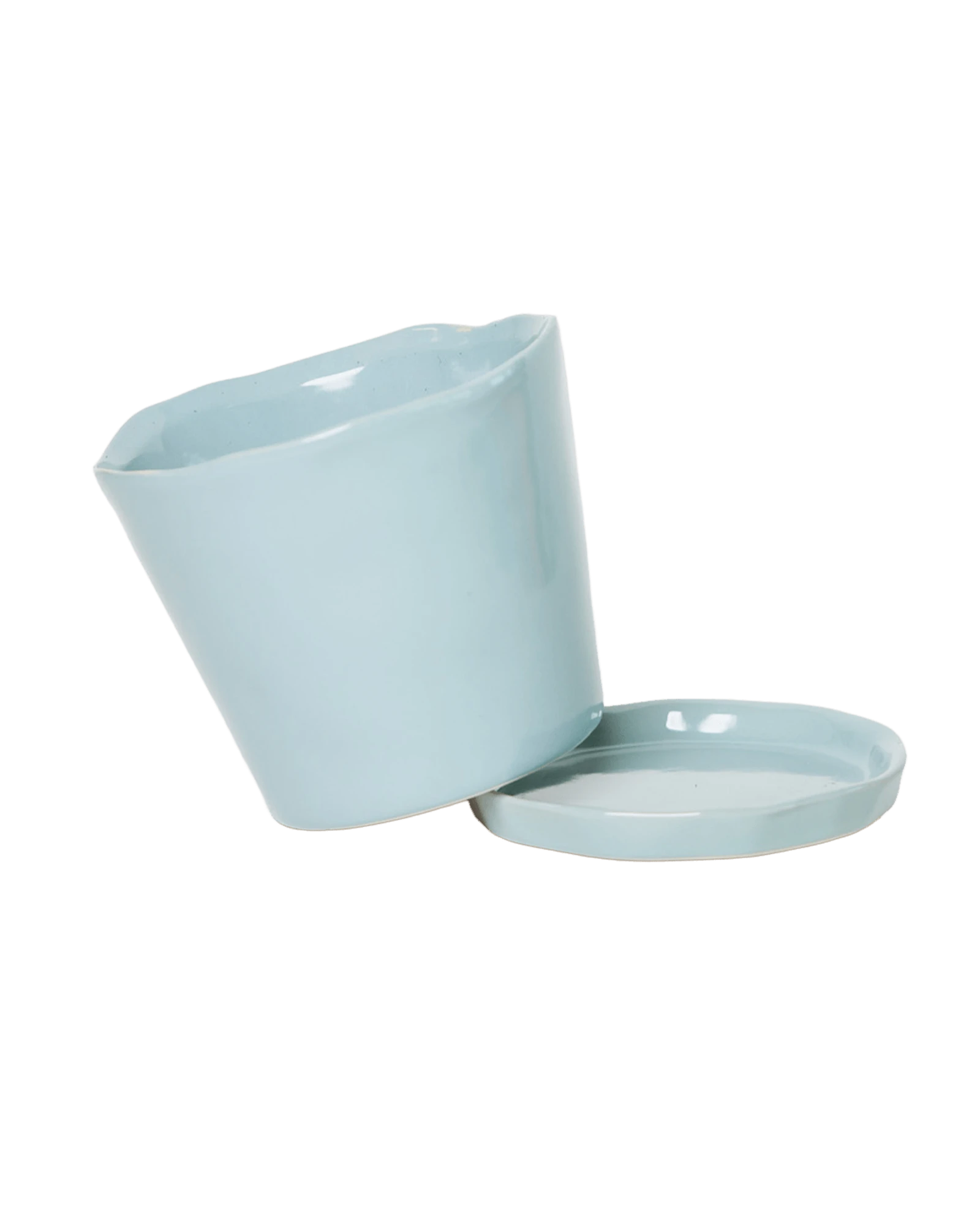 Close-up of the detachable saucer and drainage hole on a Chive Tika new grey ceramic pot.